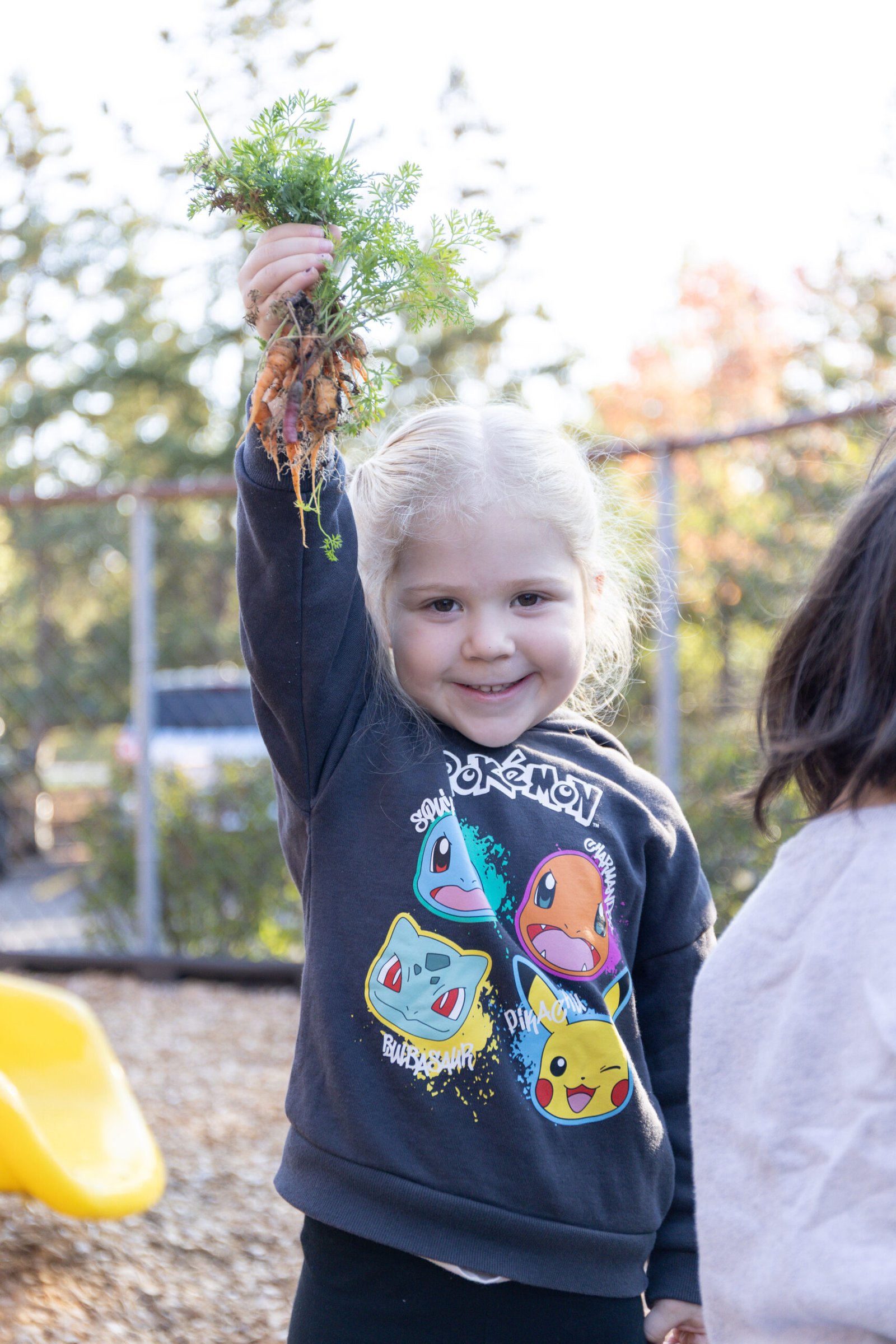 Caring teachers with children in the garden at Kiddy Garden Schaumburg
